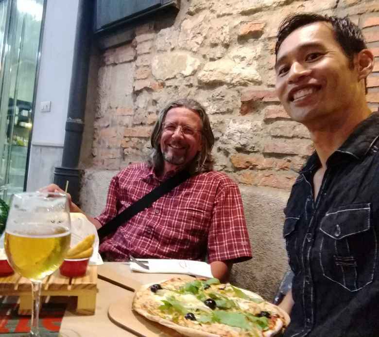Thomas from Germany and Felix Wong enjoying pizza and beer for dinner in Santander.