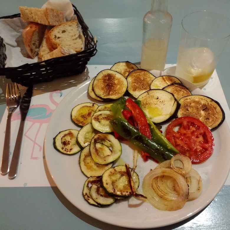Bread and vegetables (cucumbers, onions, and tomatoes) grilled in olive oil and garlic in a nice restaurant in Nueva, Spain.