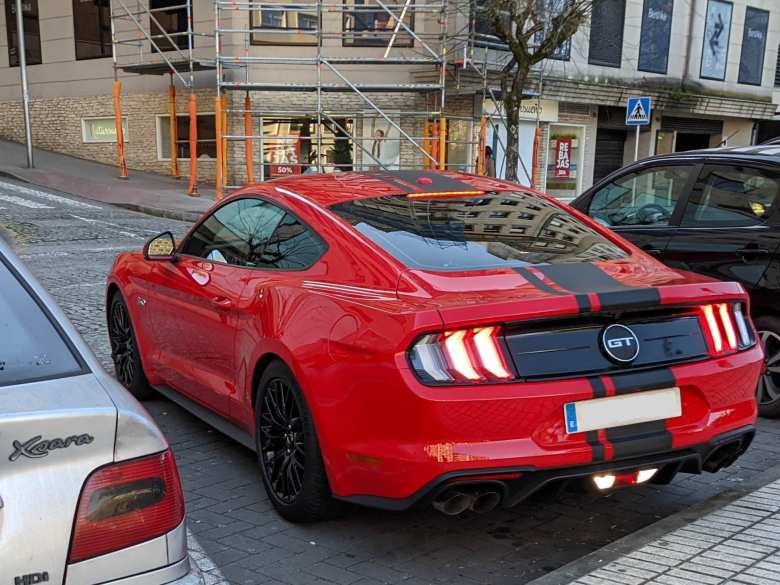 A red Ford Mustang GT coupe in Pontevedra, Spain.