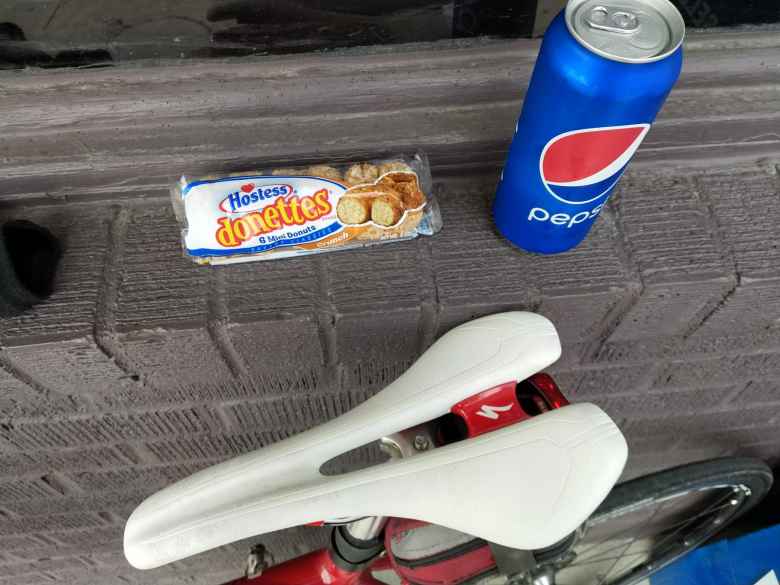 Hostess Donettes and a 16-ounce Pepsi from a convenience store. The white bicycle saddle is a Specialized Romin Evo Pro 143mm.