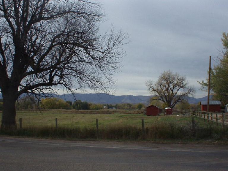 Red barns in front of the Front Range.