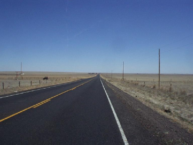 Highway 14 with no cars on it next to yellow grasslands.