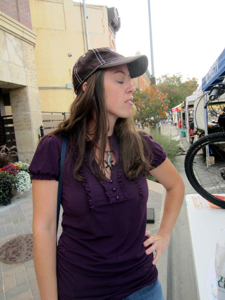 Colleen modeling a hat I won for her by answering "expert-level" bicycle trivia questions correctly.