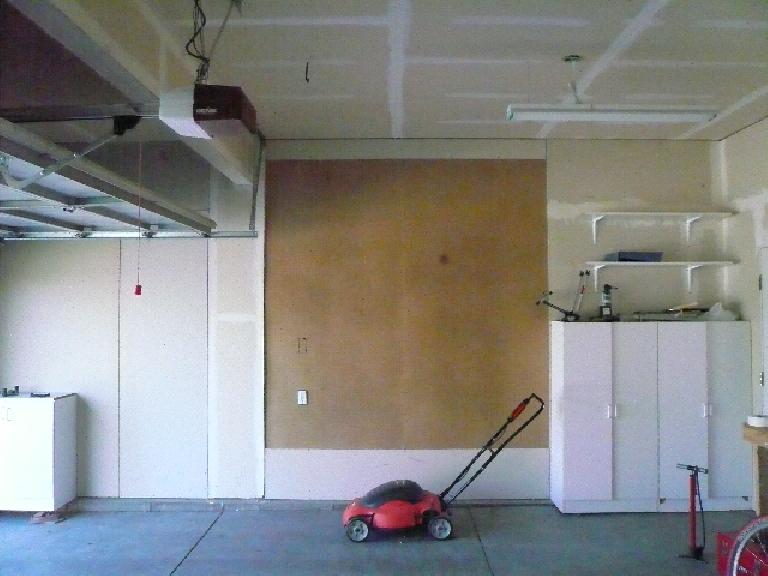 [Before] The garage had these pieces of ugly pegboard in place of drywall.  Note untaped drywall seams.