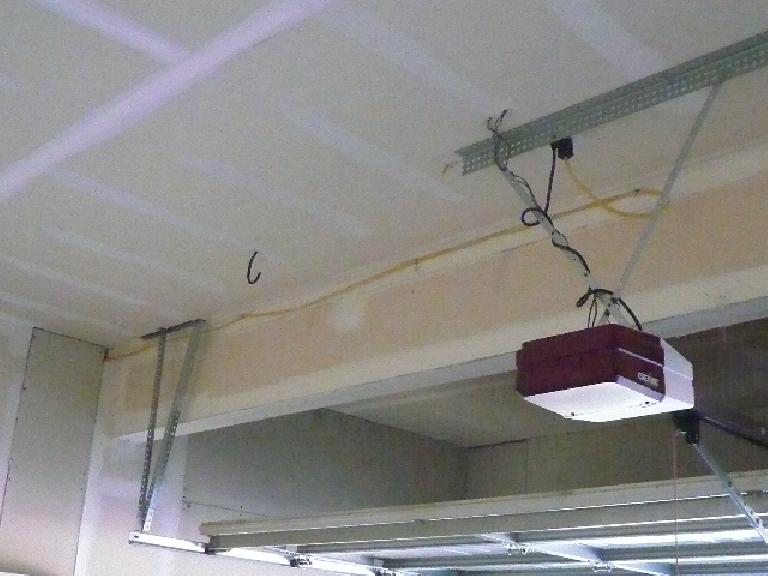 [Before] This yellow wire provided power to an outlet on a side wall, but was left exposed!  I ran it through the ceiling.