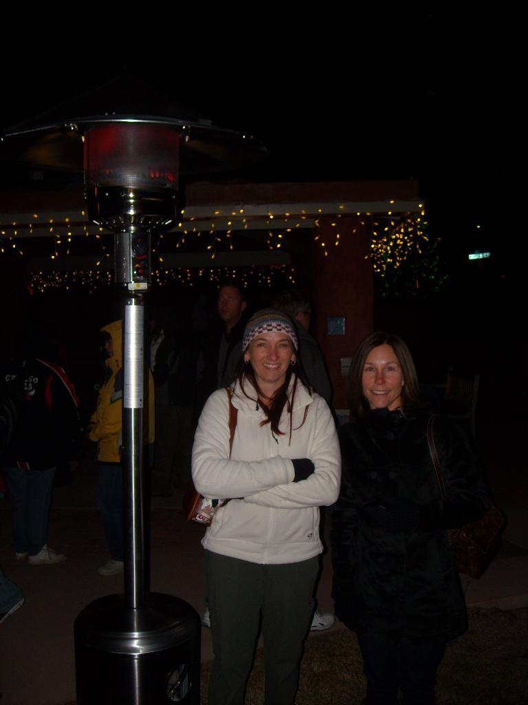Tori and Lisa keeping their heads warm by the heat lamp.