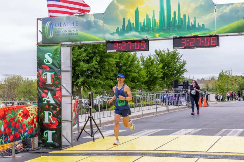 Felix Wong crossing the finish line of the Garmin Olathe Marathon.