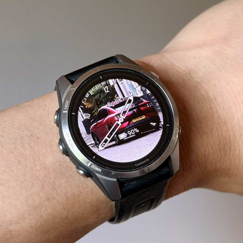 The Face It® watch face on my Garmin epix Pro (Gen 2) watch, using a photo I took in London of a red British brother of my Mustang Mach-E.