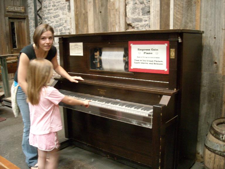 Leah and Faith with a functional player piano at the Ghost Town Museum.