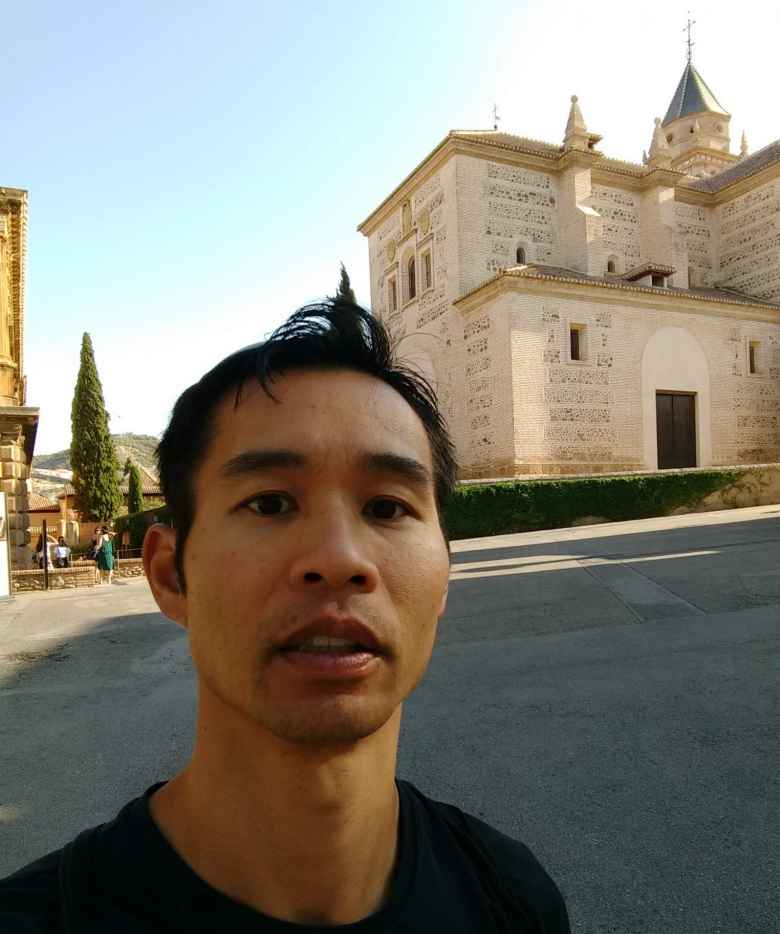 Felix Wong in front of Palacio Carlos V at the Alhambra.
