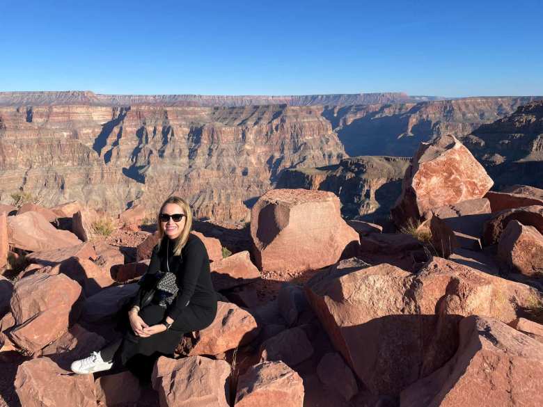 Andrea sitting on a rock at Grand Canyon West.
