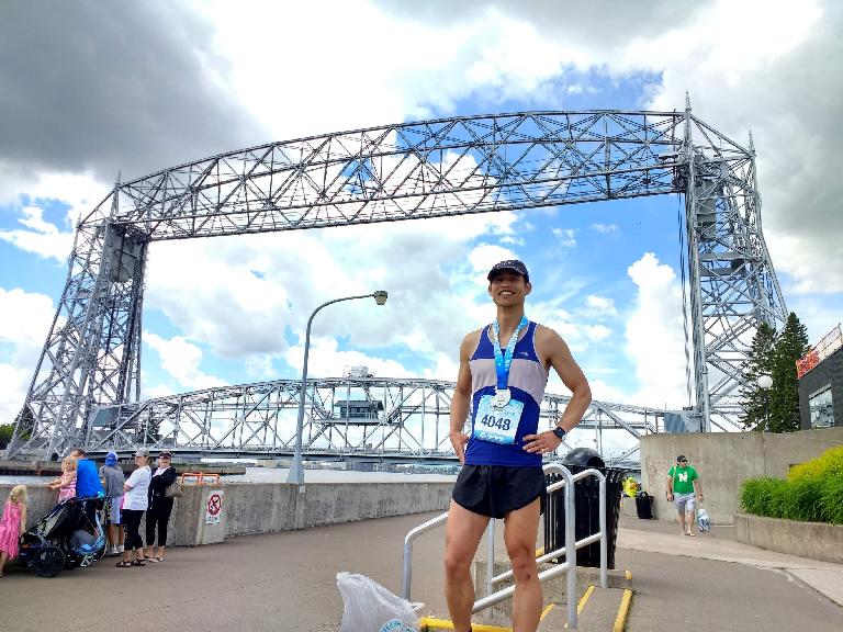 Felix Wong with the Aerial Lift Bridge in Duluth, MN after the 2017 Grandma's Marathon.