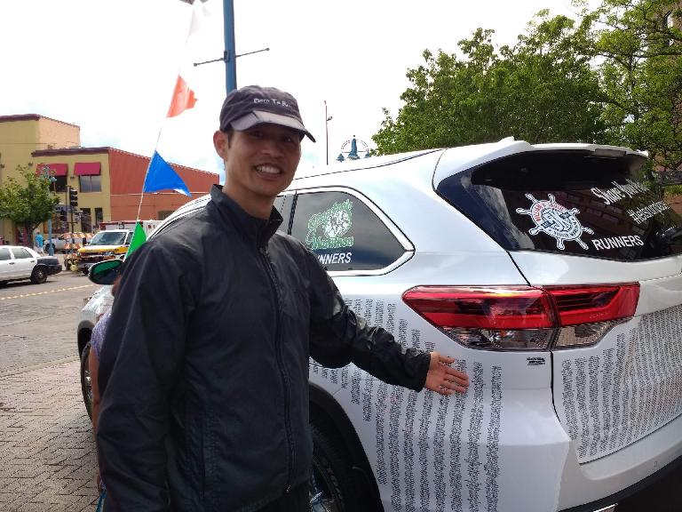 Felix Wong with a Toyota Highlander wrapped with the list of all participants' names in the 2017 Grandma's Marathon.
