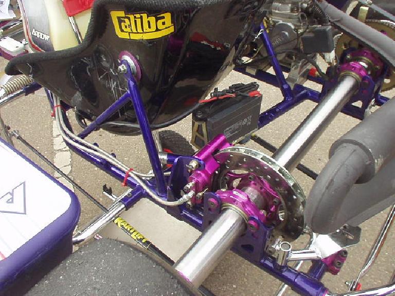 This offset disc brake (in the rear) is the only brake on the car.  Some go-karts have brakes on all four corners.