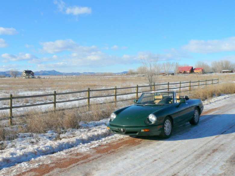 Elaina, my Foglio Green Alfa Romeo Spider Veloce, on snow-covered North County Road 13 in Fort Collins, Colorado.