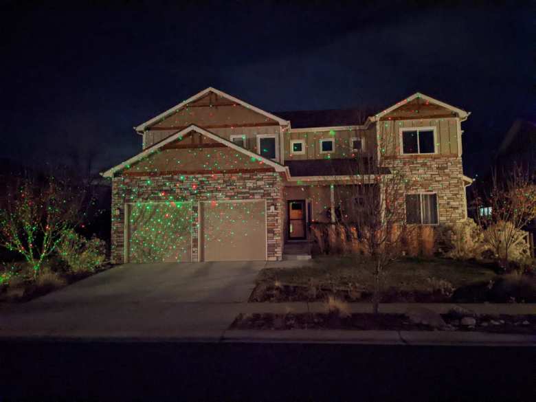 This house used projector lights to project Christmas colors on the front of the house.