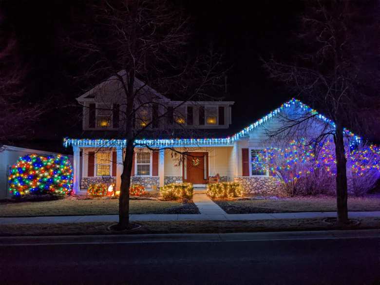 A house in the Hearthfire neighborhood with very colorful Christmas lights.