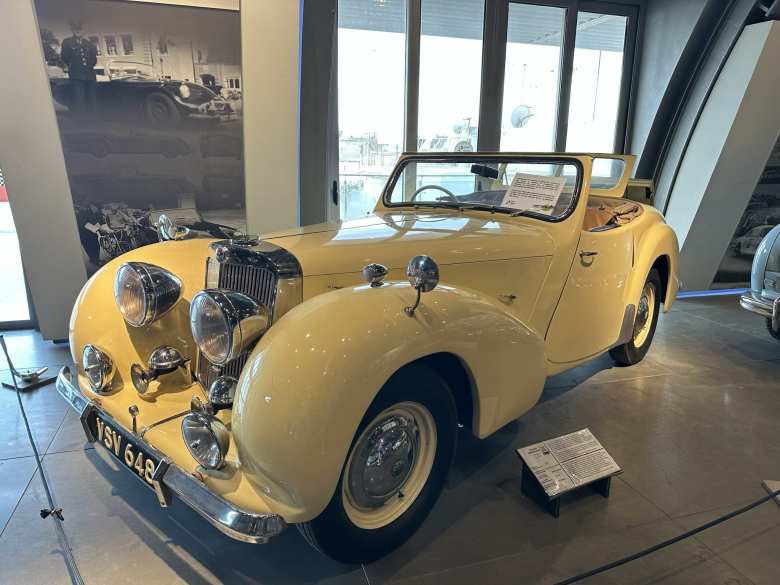 A yellow 1949 Triumph 2000 Roadster.