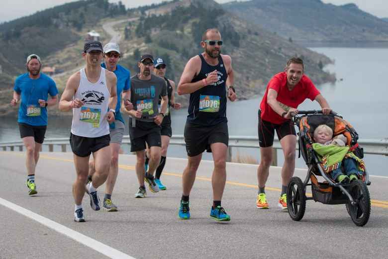 Felix Wong (white) running with Alex (black), Mike (red), and Jamo (stroller) up Monster Mountain in the 2017 Horsetooth Half Marathon.