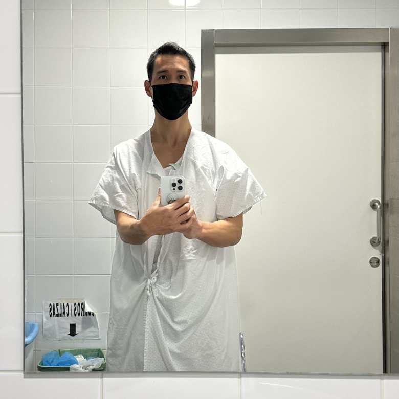 Putting on a hospital gown in a bathroom inside Hospital Miguel Domingüez.