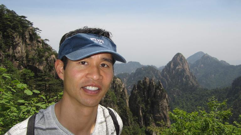 Felix Wong in front of the "five fingers" in the Huangshan Mountains.