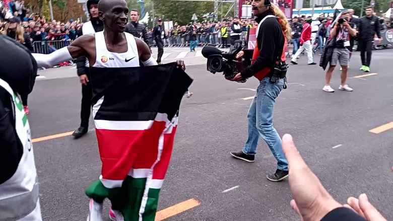 After finishing, Kipchoge ran around with the Kenyan flag. He missed slapping my outstretched hand in this photo.