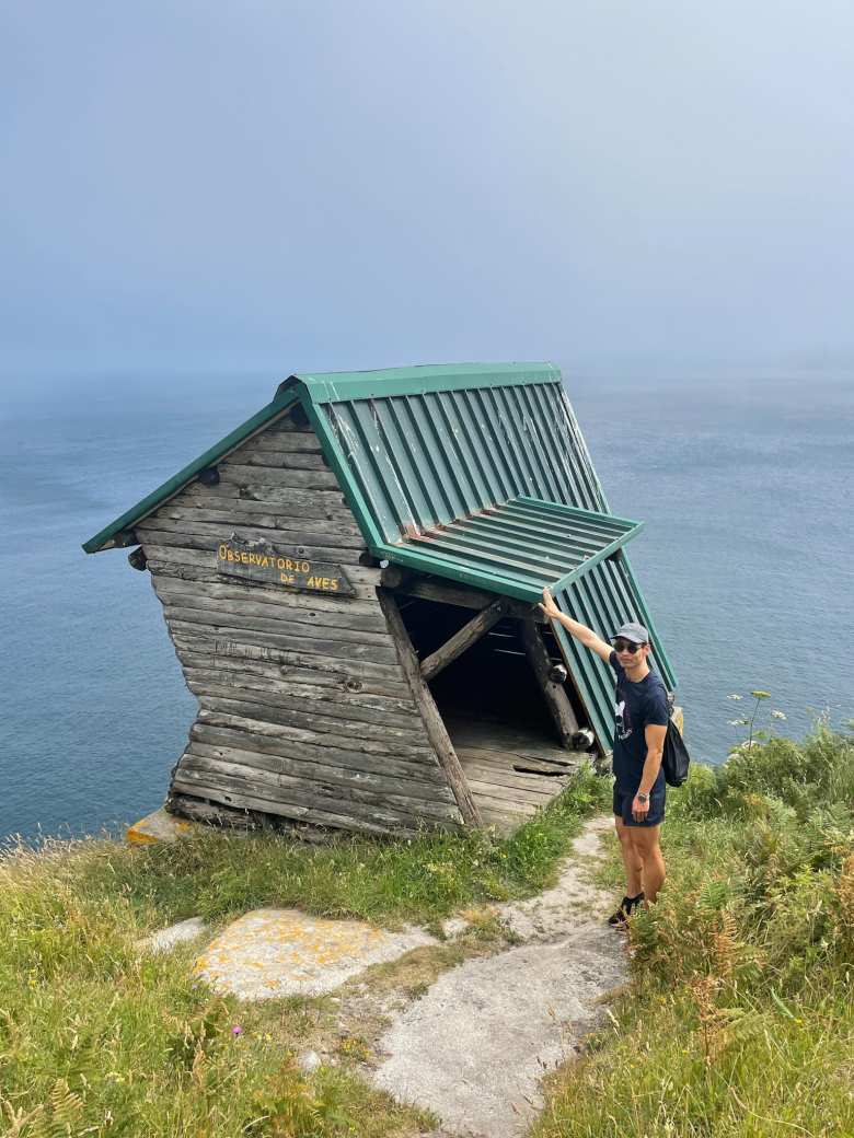 Felix with his hand on the leaning Observatorio de Aves (Bird Observatory) on the north end of Islas Cíes.