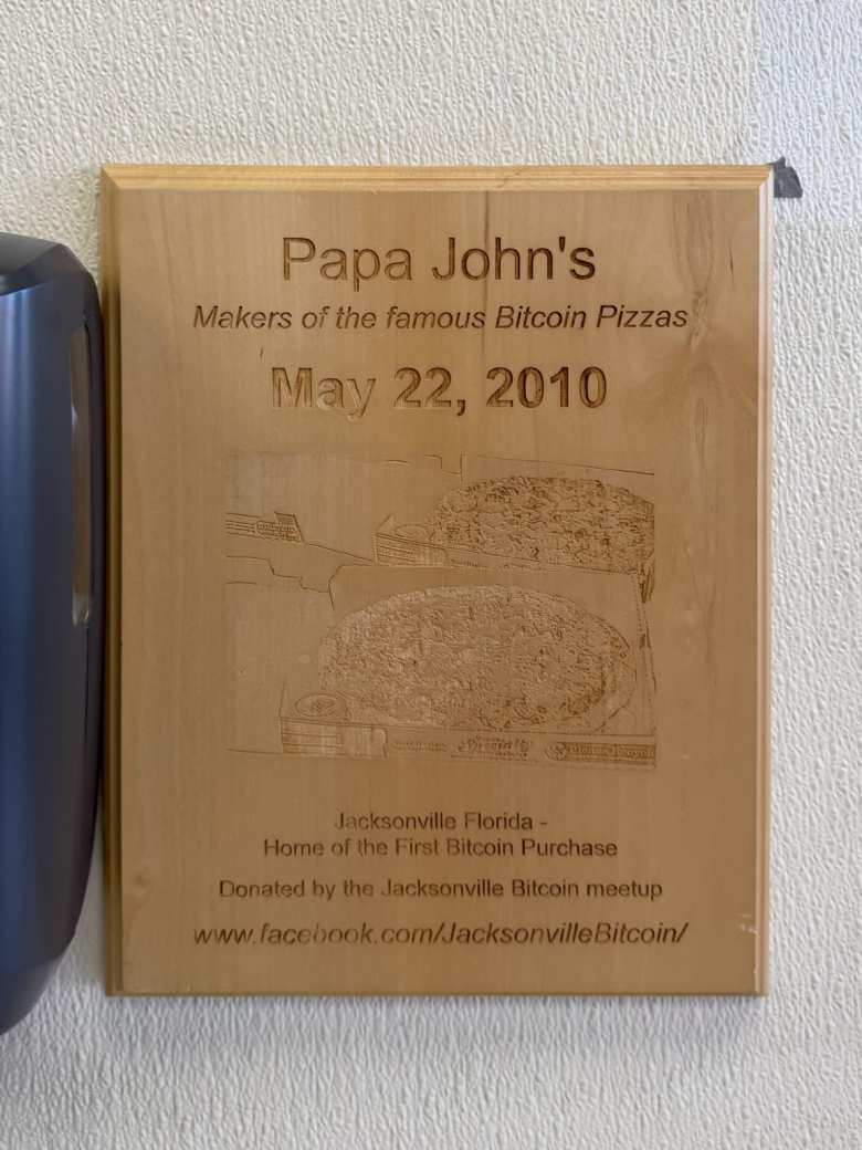 This wooden plaque was on the wall inside the Papa John's where the world's first Bitcoin purchase was made. It was donated by the Jacksonville Bitcoin meetup.