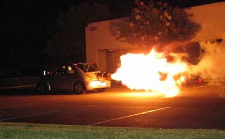 flames shooting out of jet-powered New Beetle at night