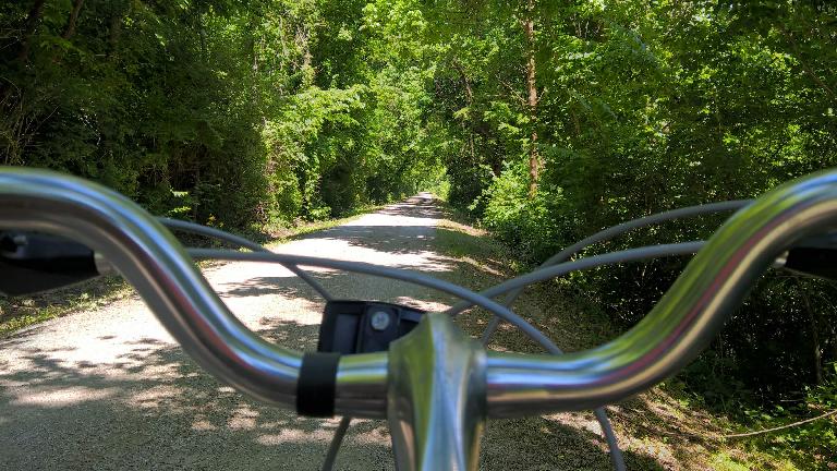 The view behind the handlebars of the rental bike on the Katy Trail.