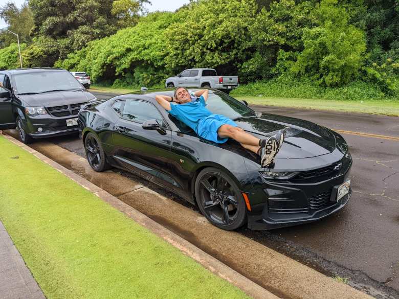 Dave in his black Camaro rental car.