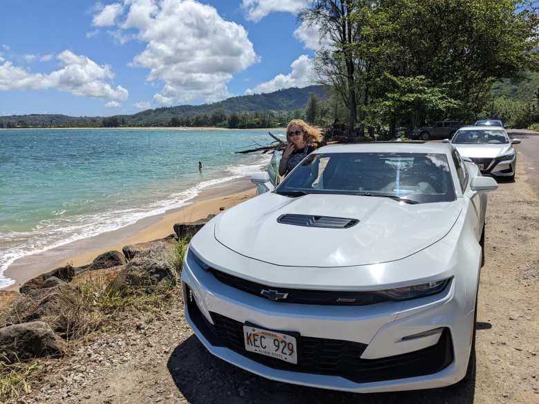 Andrea with our white Camaro rental car in Hanalei, which we had for a day to replace the Dodge Grand Caravan rental car whose transmission broke.