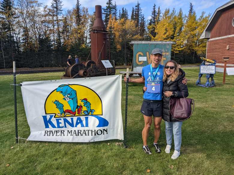 Felix and Andrea by the Kenai River Marathon sign.