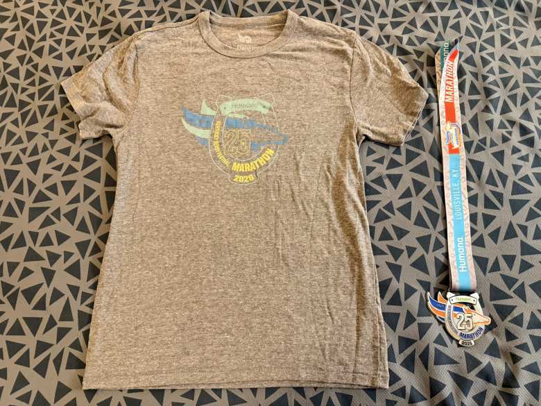 The race shirt and finisher's medal for the Kentucky Derby Festival Marathon.