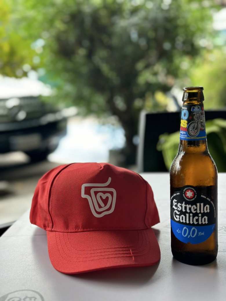 As we walked into Padrón, there was someone from the French grocery chain Carrefour giving out red hats. Here's mine with a bottle of Estrella Galicia 0,0.