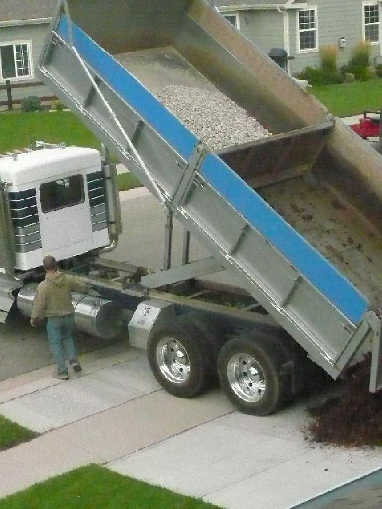 A dump truck unloaded one ton of rock and six cubic yards of shredded mulch on my driveway.