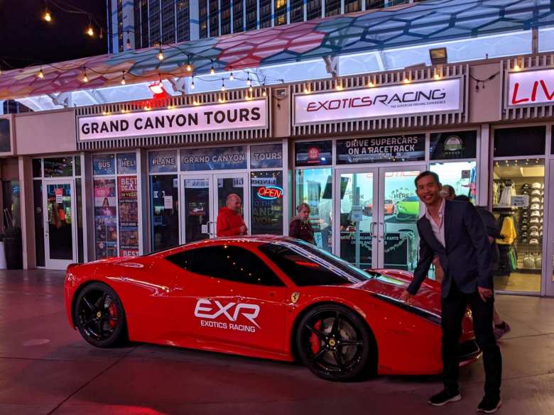 Felix Wong standing next to a red Ferrari 458 Italia in Las Vegas.