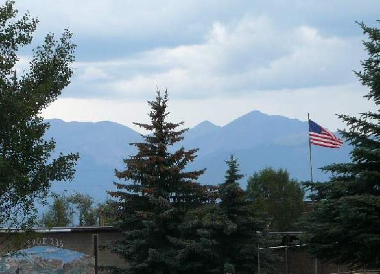 Flag waving in downtown Leadville with the mountains behind. Flag waving in downtown Leadville with the mountains behind.