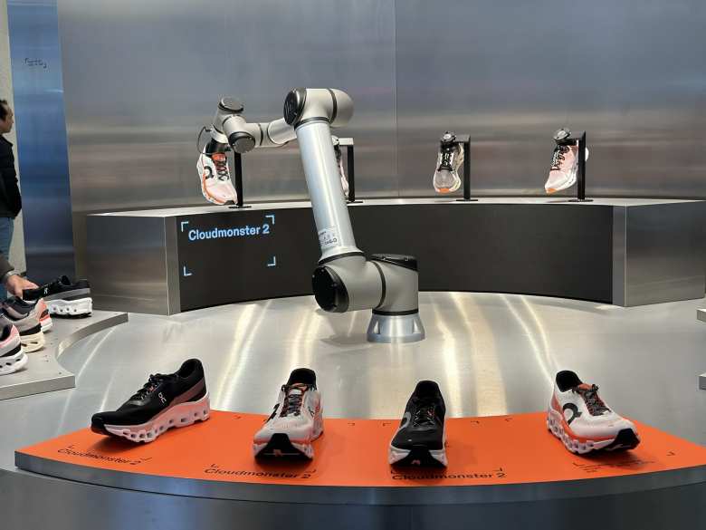 A robot was handling On running shoes inside the On store off Regency Street in London.
