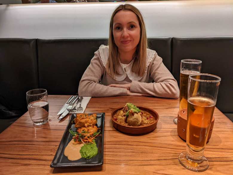 Andrea with Indian food at the Cinnamon Kitchen near Liverpool Street, London.