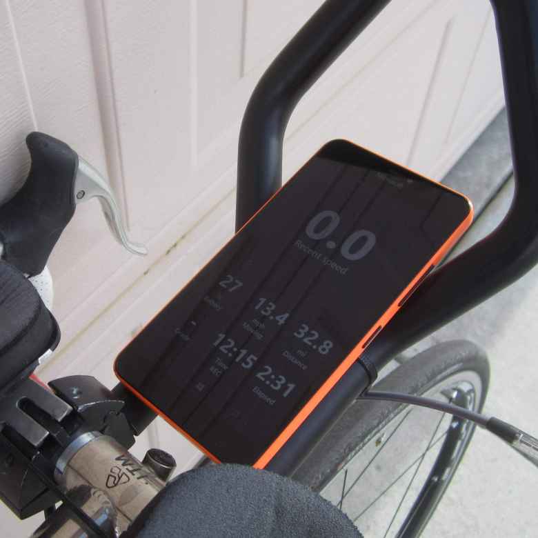 orange Microsoft Lumia 640 XL mounted on bicycle aerobars, Cycle Tracks hide map mode