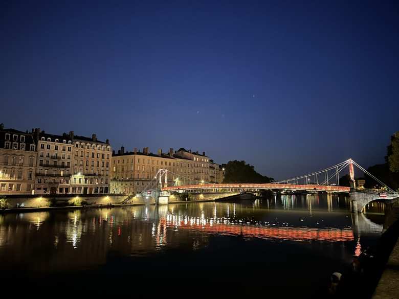 A lit-up bridge over the Rio Saona in Lyon.