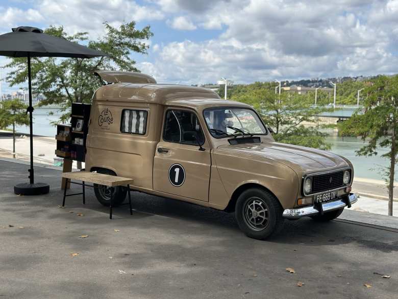A classic, taupe-colored Renault 4 owned by La Course Café in Lyon.