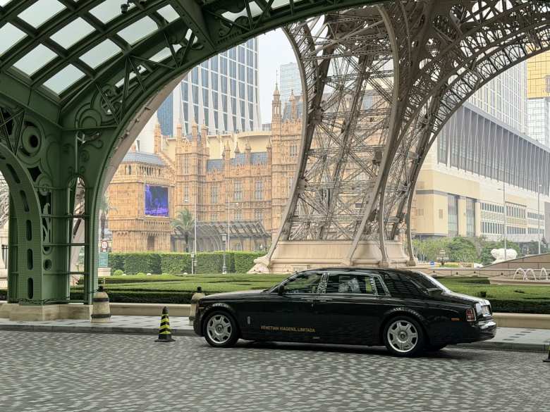 A Rolls-Royce waits underneath the Eiffel Tower of Macau.