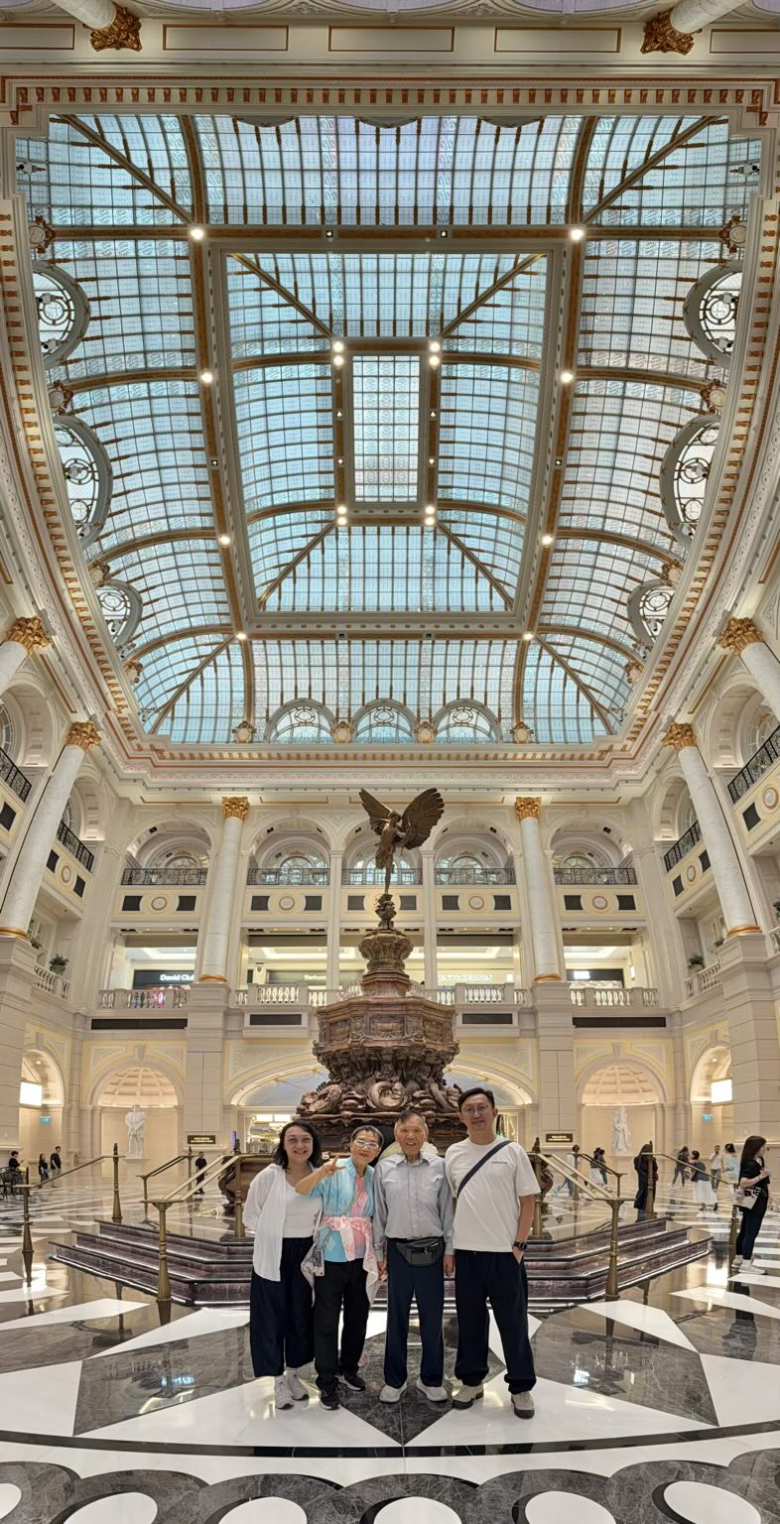 My cousin, aunt, dad, and Samuel in front of a winged statue at the Shoppes at Londoner.
