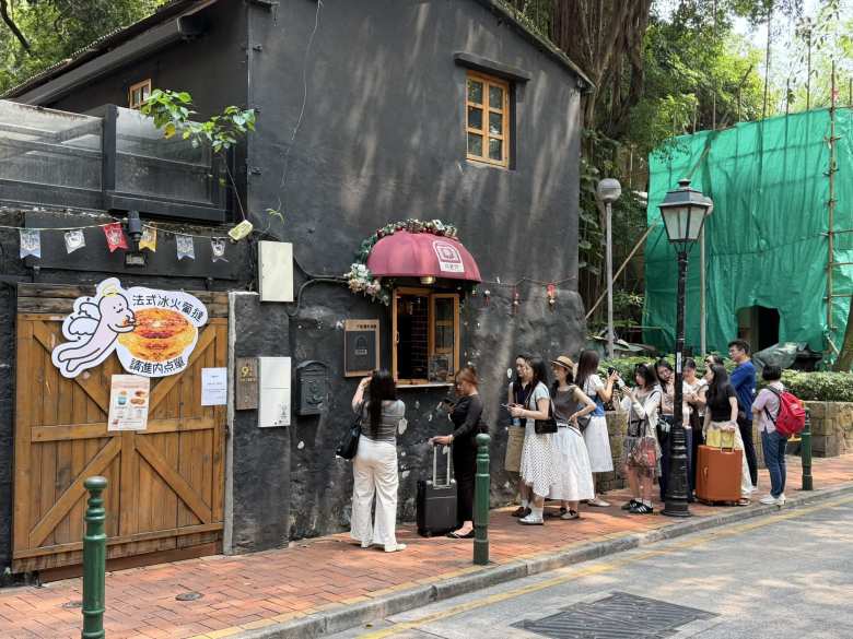 Egg tarts are sold all over Macau. The ones people are lining up for here are "French-style" ones.