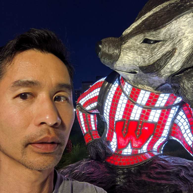 Felix Wong with a University of Wisconsin mascot.