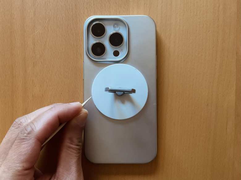 Touching up a MagSafe ring stand with white model paint.