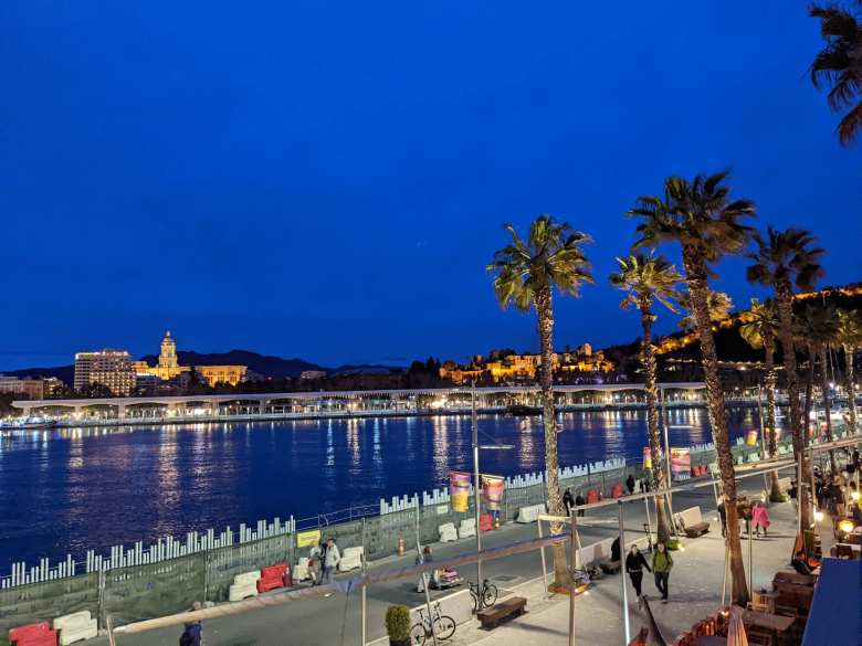 The view of the center of Malaga and the Alcazaba from Malagueta at night.