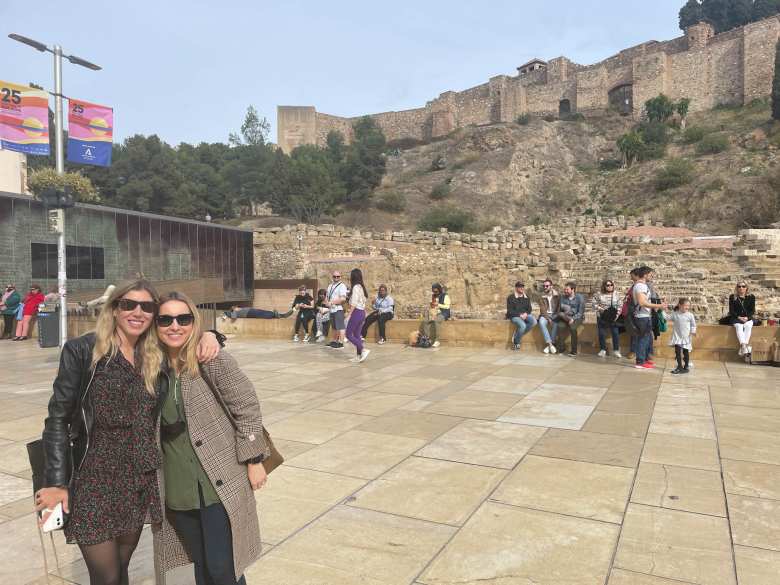 Marina and Andrea with the Roman Theater and Alcazaba behind.